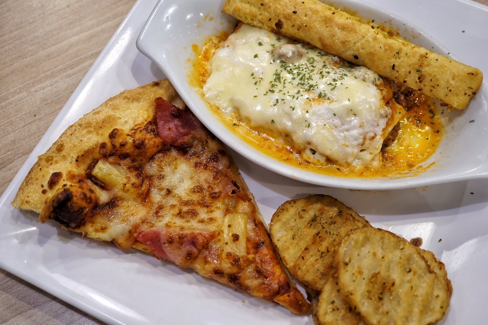Beef lasagna supreme with pizza slice and drink